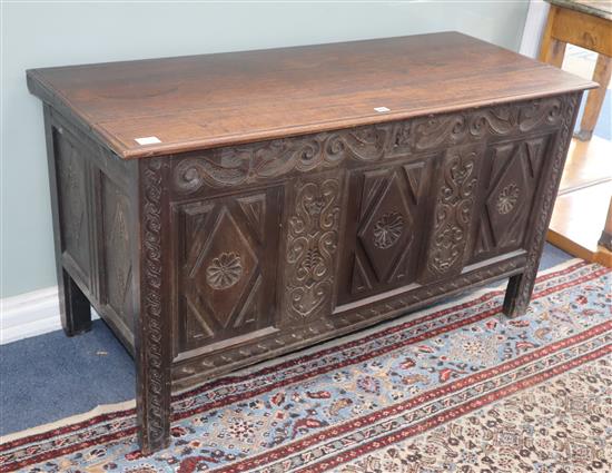 A large carved oak coffer W.134cm